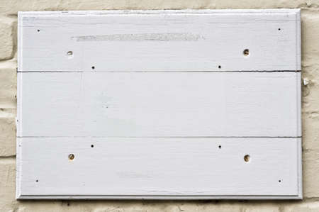 White wooden panels on a brick wallの写真素材