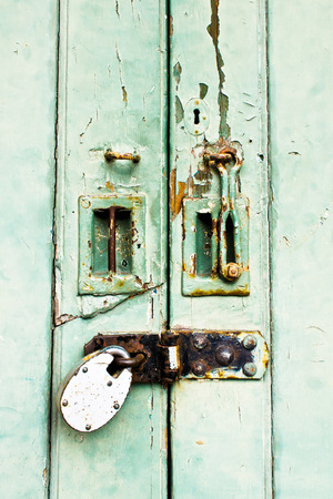 Part of a locked double wooden doorの写真素材