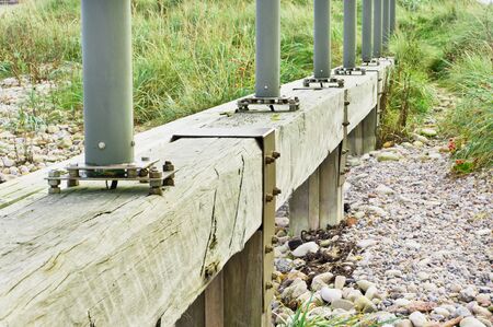 The base of a row of runway lights attached to a wooden plank