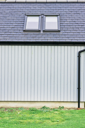 Part of a modern wooden eco building with skylights in the roof