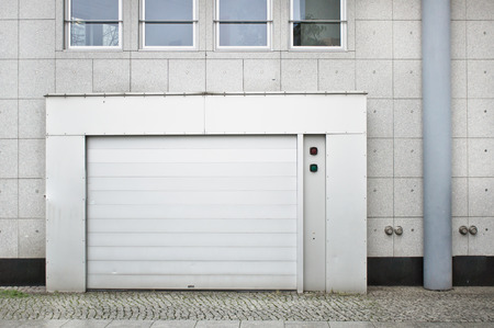 A large white door in an urban building for vehicle entryの写真素材