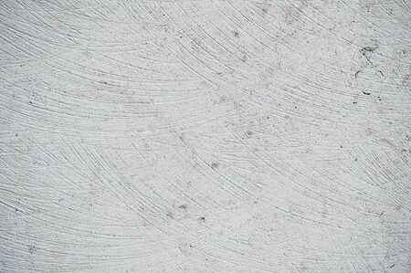 A scratched stone surface as a background etxtureの写真素材