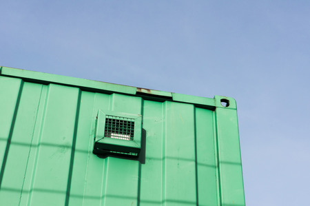 Part of the exterior of a green metal storageの写真素材