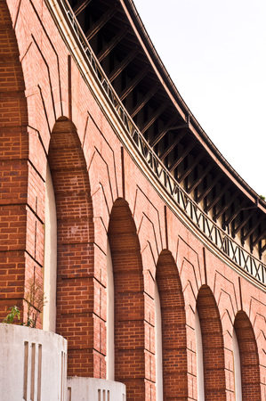 Part of the external wall of a renovated brick building in the UK with tall archesの写真素材