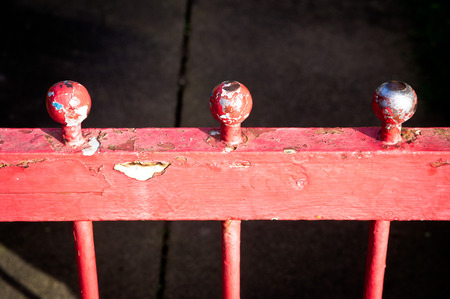 Part of a red metal railing