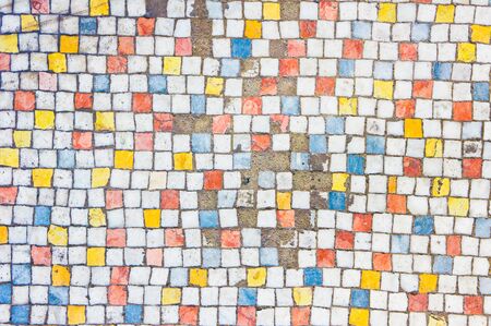 A background of old broken colourful tilesの写真素材