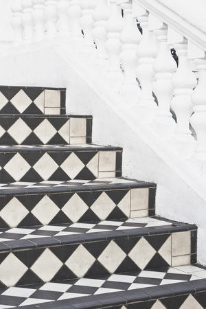 Part of a set of stone steps with decorative tiles at the entrance to a houseの写真素材