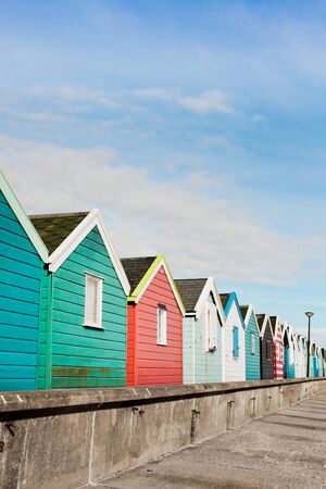 A row of colourful beach huts in Southwold, UK