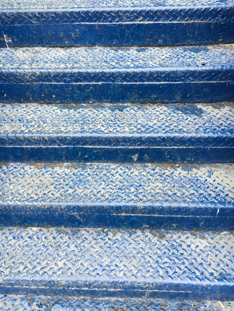 Part of a set of blue metal steps as a backgroundの写真素材