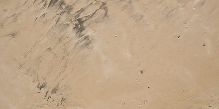 A background of wet sand