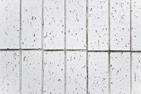 Worn white wall tiles as a backgroundの写真素材