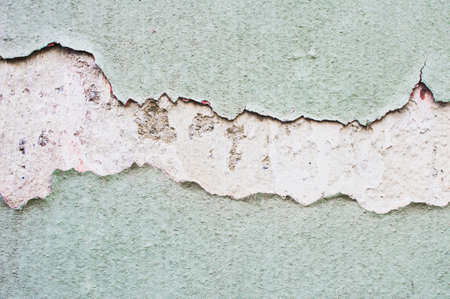 Part of stone wall with peeling paint and plasterの写真素材