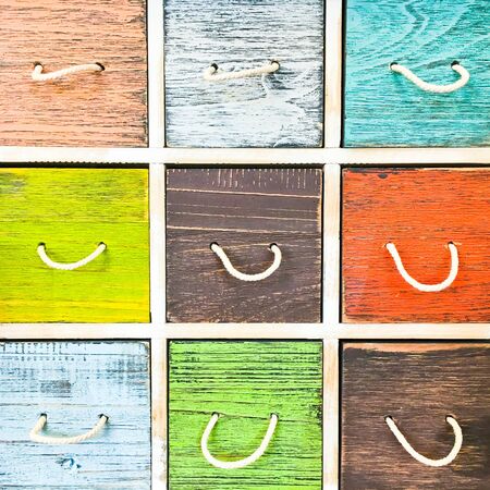 Colorful wooden drawers on a wooden cabinetの写真素材