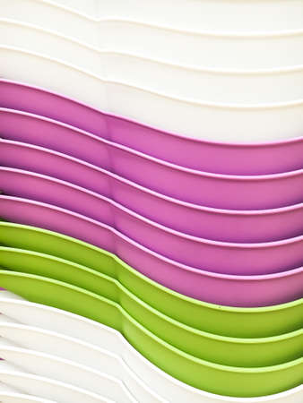 Close up of some stacked colourful plastic containers as a backgroundの写真素材
