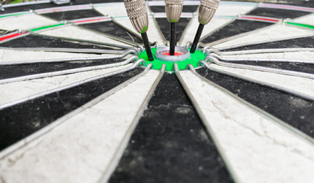 Three darts in the centre of a dartboardの写真素材