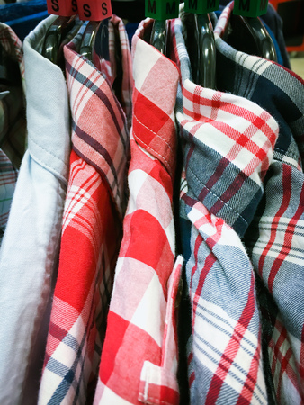 Casual men's shirts hanging on a rackの写真素材