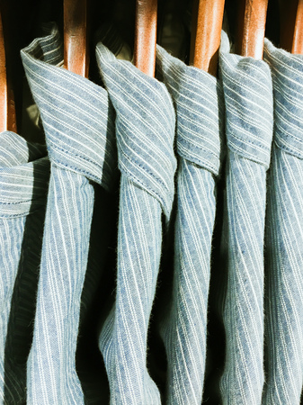 Casual men's shirts hanging on a rackの写真素材