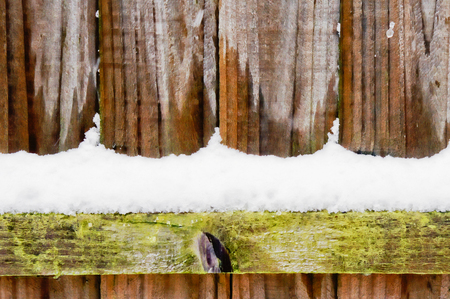 Part of a wooden fence wih snowの写真素材