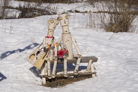 Natural Park Bazhov place, Sysert, Russia - March 28, 2015: Loving couple of fabulous little people sitting on a wooden bench in the forestのeditorial素材