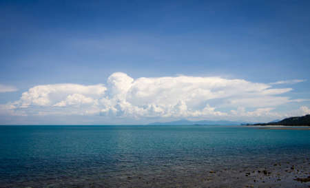 Big clouds and blue tranquil seaの写真素材