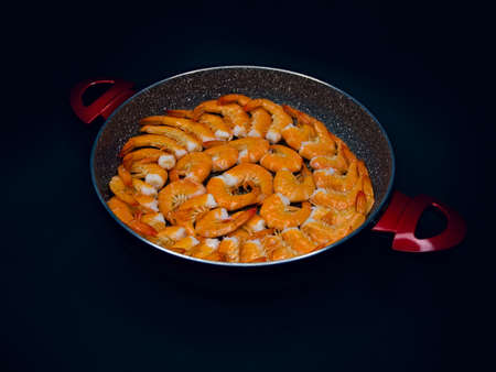 Fresh Mediterranean prawns in a pan on a black backgroundの写真素材