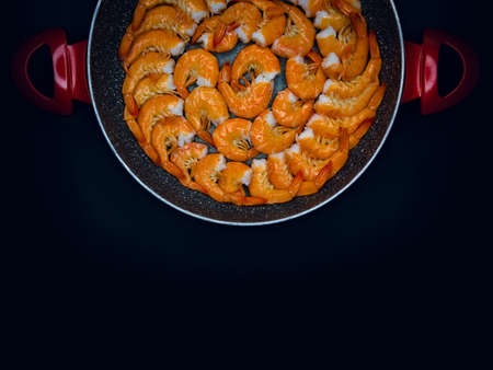 Fresh Mediterranean prawns in a pan on a black backgroundの写真素材