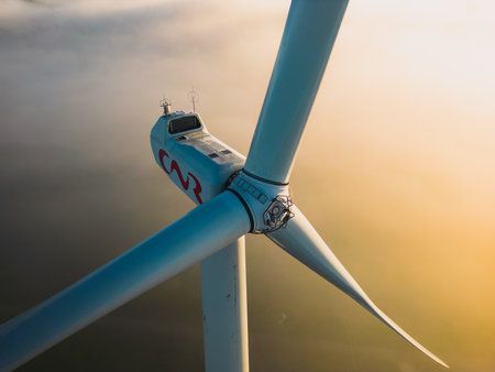 Le Pouzin, France - 2 Octobre, 2022: Close-up on the propellers of a wind turbine during a misty morning and sunrise. Green energy. Wind turbine at morning fogのeditorial素材