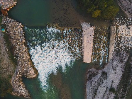 Beautiful Little Waterfall on the Drome River formed from great stones in a mountainous region. A waterfall during the sunset. Aerial Drone Shotの写真素材