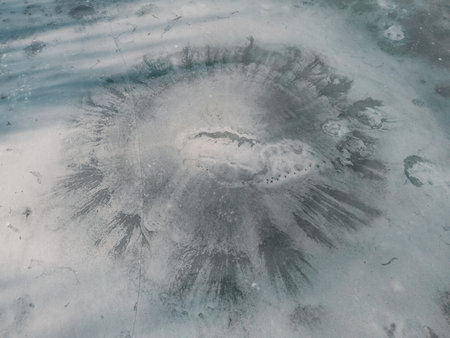 Aerial view of a frozen lake. Ice sheet background. Frozen waves on the lake. ice background. Ice cover on a lake in southern Poland in the Bieszczady Mountainsの写真素材