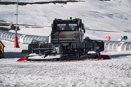 Huez, France - 9 April 2023: Snowcat, ratrack PistenBully - machine for snow preparation while working in Alpe D'huez - One of the most popular ski resorts in the Alps in Franceのeditorial素材