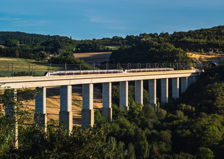 Grane, France - August 2023: Panoramic view on passenger train TGV crossing the railway flyover....