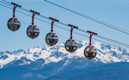 Cable car on the background of snow-capped mountains.