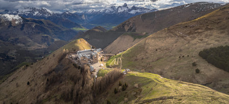 Panoramic view of La Salette Sanctuary bathed in sunlight, with snow-capped mountain peaks in the background and a peaceful alpine landscapeの写真素材