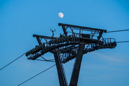 Cable Car Over Solina Lake Dam at Dusk with Full Moon in the Background, Bieszczady Mountains,...
