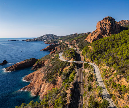 Panoramic aerial view of Esterel Mountains coastline with winding coastal road and railway tracks above the Mediterranean Sea, French Riviera, Southern France, scenic cliffs and ocの写真素材