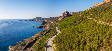 Panoramic aerial view of Esterel Mountains coastline with winding coastal road and railway tracks above the Mediterranean Sea, French Riviera, Southern France, scenic cliffs and ocの写真素材