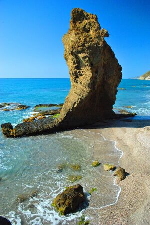 a stack of rock in the mediterranean sea on the coast of spainの写真素材