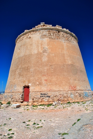 ruined tower against deep blue sky の写真素材