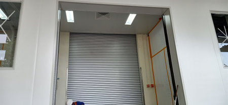 Closed door of industrial building with metal roller shutter door in the factoryの写真素材