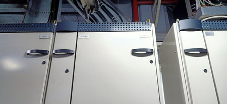 Row of stainless steel door lockers in a modern factory building.