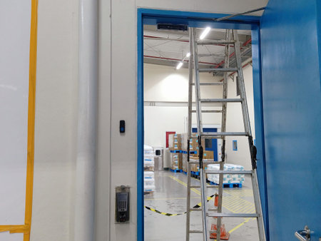 Interior of a warehouse with a ladder and scaffolding in a factoryの写真素材