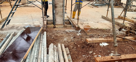 construction site with workers pouring concrete into a new house, panoramaの写真素材