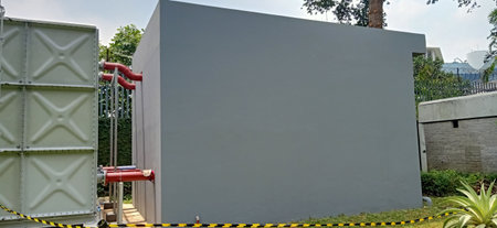 White wall with red barrier on the entrance to the park, Thailand.の写真素材