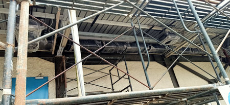 Scaffolding and scaffolding in an industrial building, construction siteの写真素材