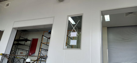 Interior of a new building with scaffolding and roller blindsの写真素材