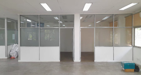 interior of a modern office building with white walls and glass doorの写真素材