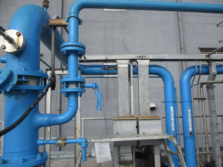 Pipes and valves in a petrochemical plant, closeup of photoの写真素材