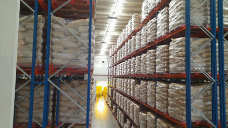 Interior of a warehouse with shelves full of boxes and palletsの写真素材