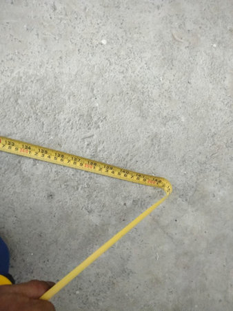 measuring tape on concrete floor in construction site with copy space.
