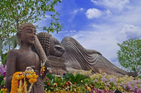 Reclining buddha statue with the  flowerの写真素材